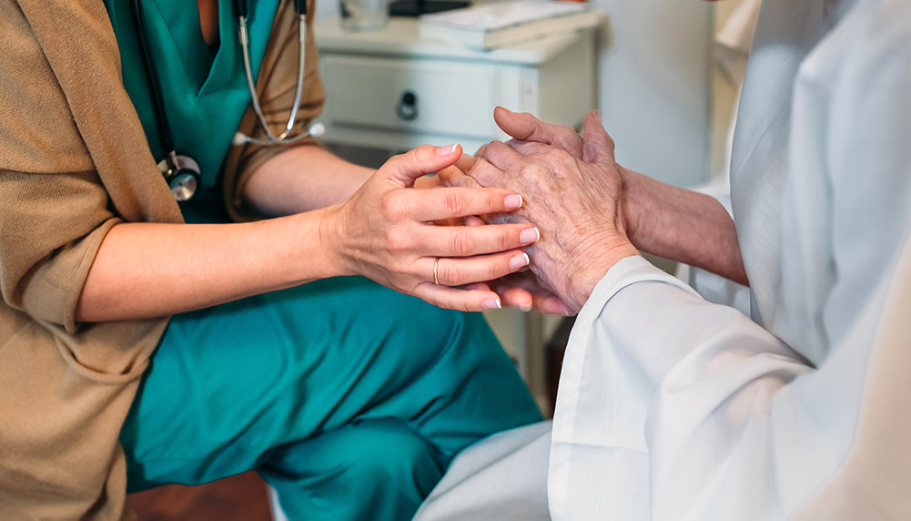 Healthcare Patient holding hands with doctor or nurse